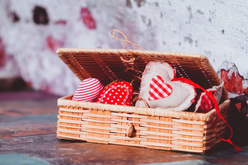 heart decorations, handmade hearts, fabric hearts, wicker basket, valentine's day, rustic decor, red and white, love symbols, romantic gift, craft project, textile art, cozy style, striped fabric, polka dot hearts, gingham heart, charming gift, heart shaped ornaments, cottagecore, boho chic, soft textures, holiday decor, heartfelt gift, diy decoration, love theme, vintage style