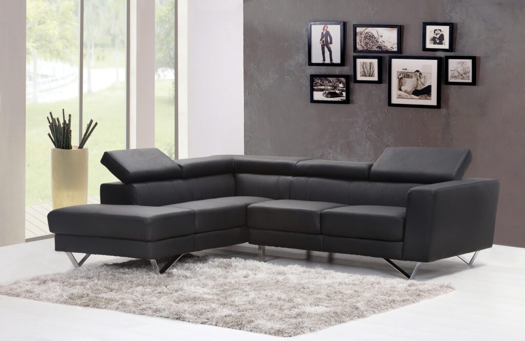 Renter-Friendly Furniture Ideas: Smart, Damage-Free Solutions for Apartments Contemporary living room featuring a sleek black sectional sofa and chic wall art.