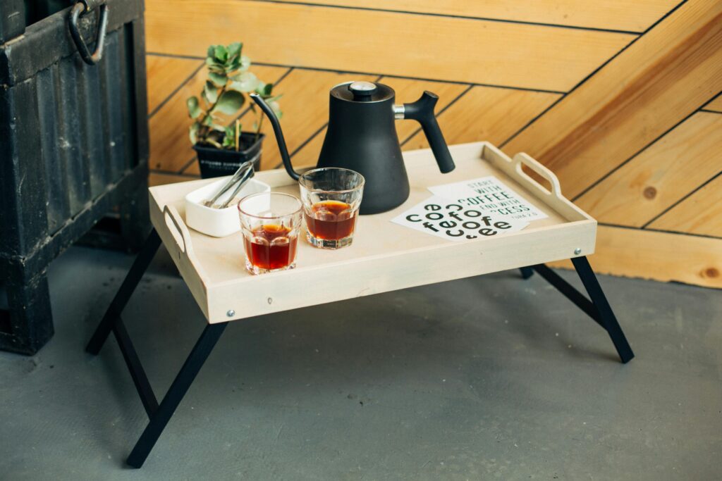 Foldable Furniture for Small Homes: Space-Saving Solutions for Apartments and Studios Modern folding table setup with teapot and coffee for a cozy indoor atmosphere.